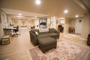 Plymouth Michigan basement living room with vinyl plank flooring and sectional couch