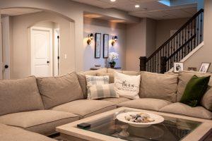 Closeup view of the living room sectional with the stairs in the background.