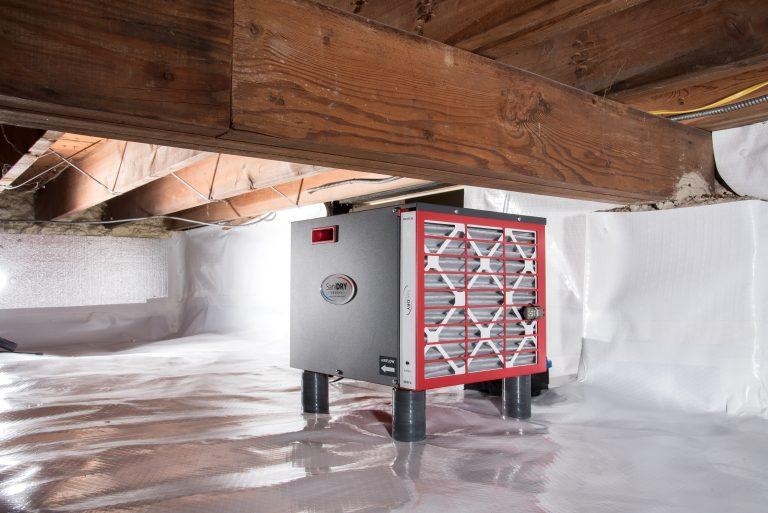 Photo of SaniDRY dehumidifier installed in a crawl space that has been protected against water intrusion by Basements Plus.