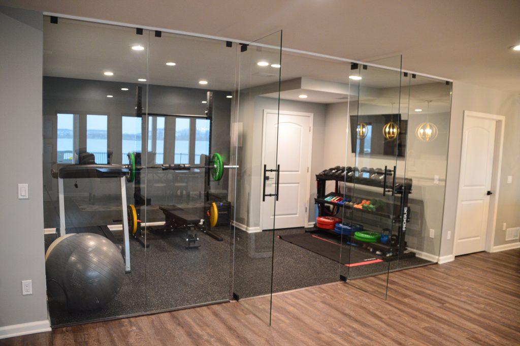 From outside looking in the home gym with a glass wall to divide the gym from the living space.