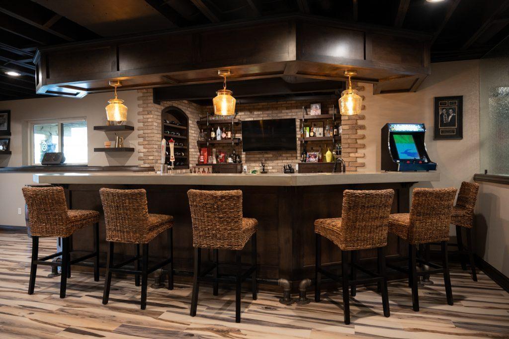 Finished basement home bar view from behind the bar stools.