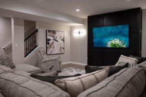 Finished basement living room with black accent wall in Northville, Michigan