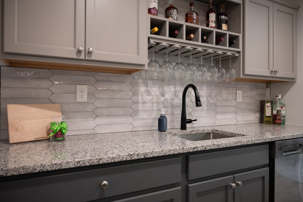 Full kitchen remodel with installed sink and hanging wine rack in Oakland TWP