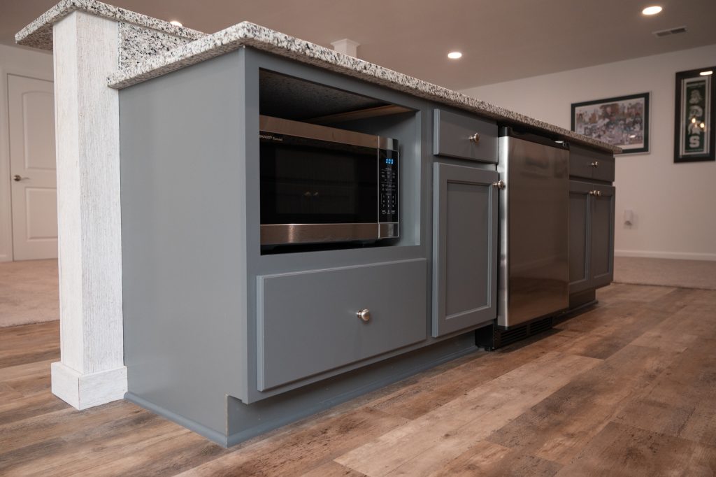 Custom shelf designed for microwave space in a finished basement